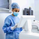 female-surgeon-with-surgical-mask-operating-room-using-3d-image-guided-surgery-machine_11zon