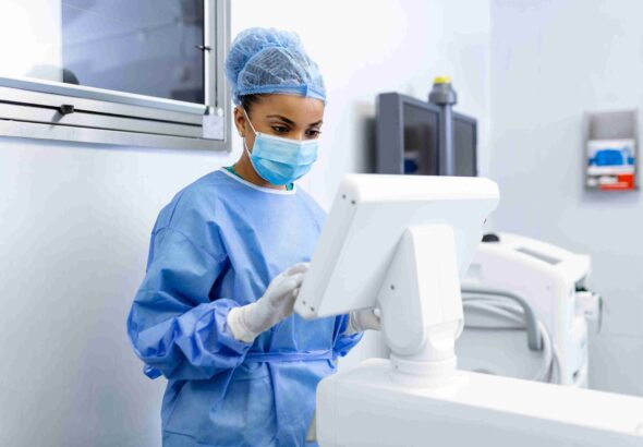 female-surgeon-with-surgical-mask-operating-room-using-3d-image-guided-surgery-machine_11zon